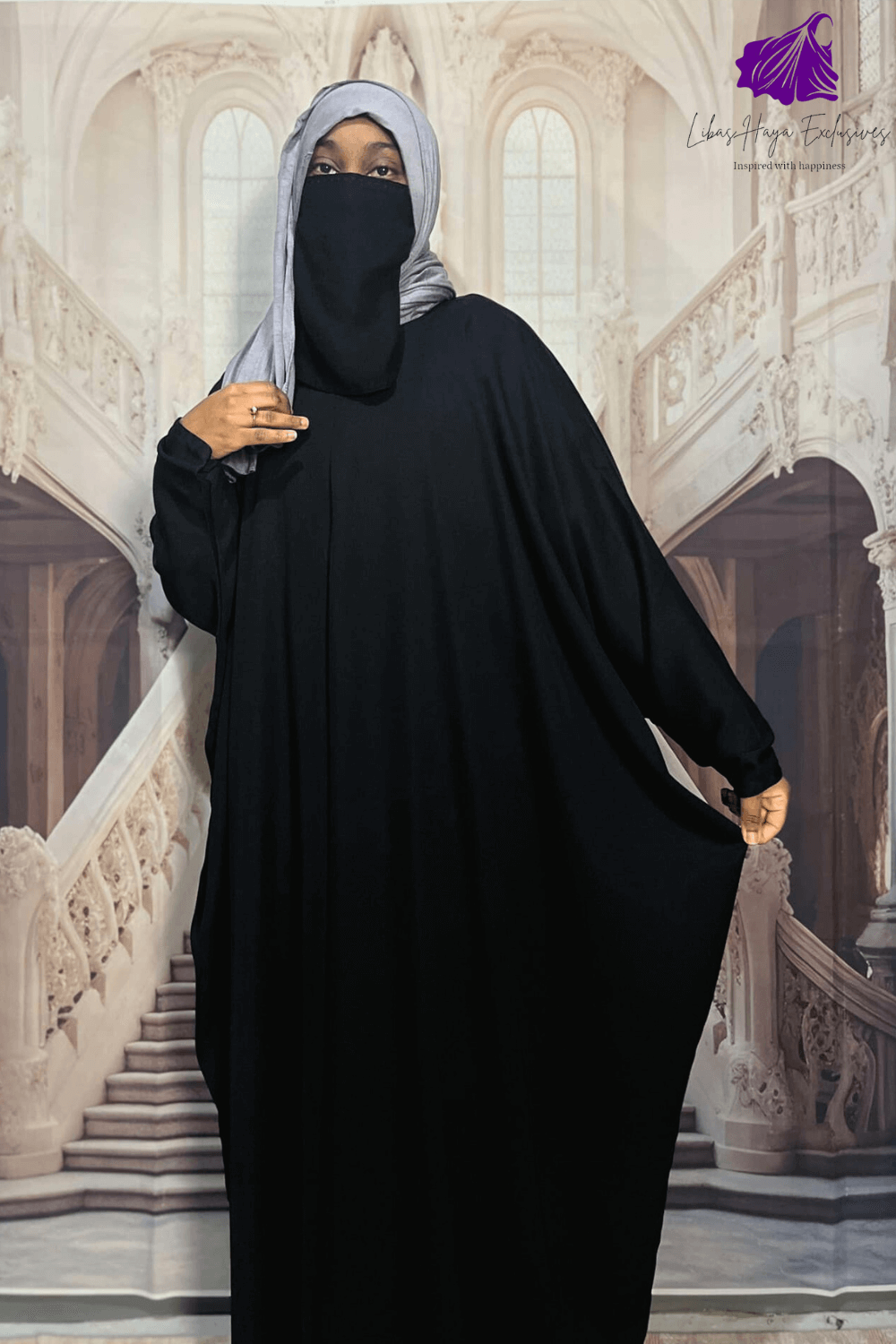 woman showing width of black abaya