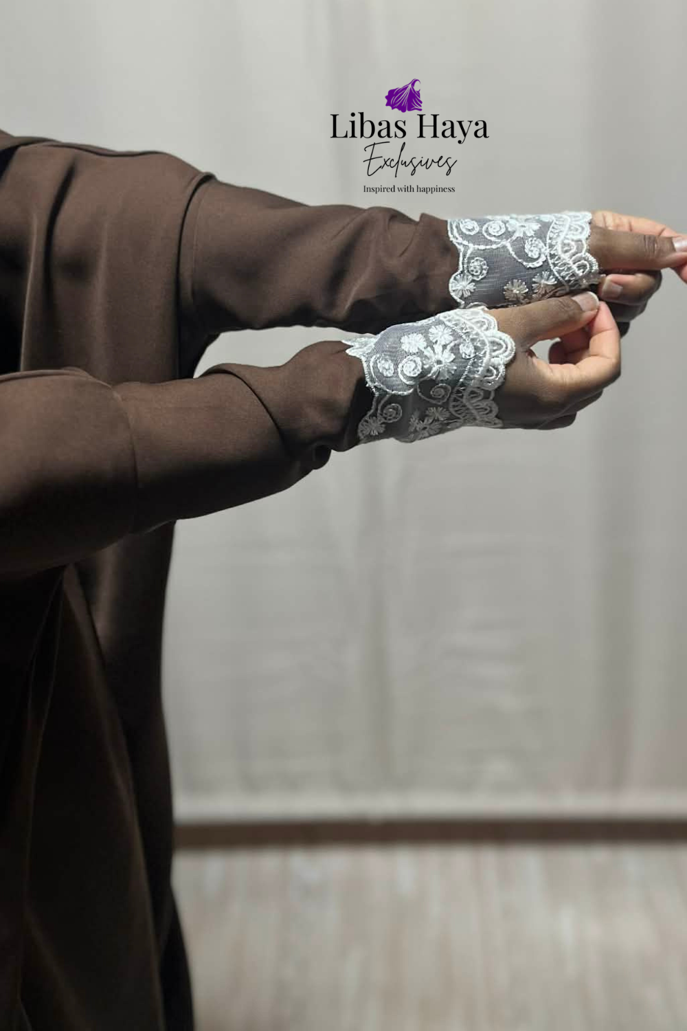 Brown jilbab with white lace cuffs worn  branded 'Libas Haya Exclusives
