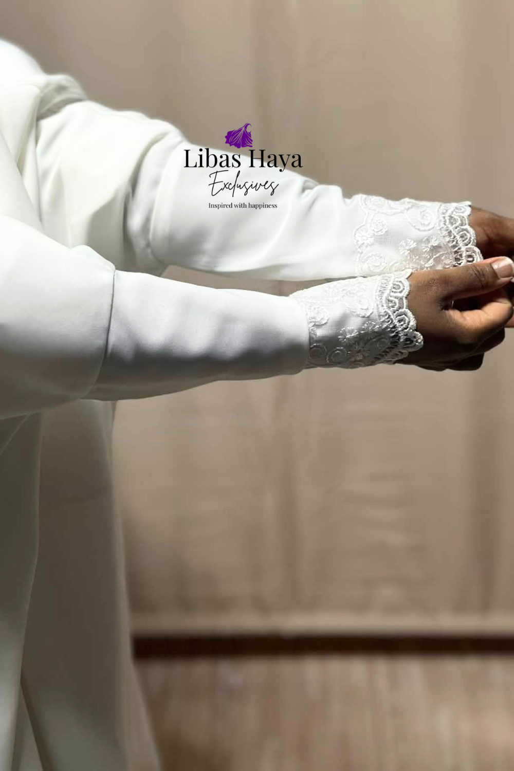 Close-up of a white long-sleeve jilbab with lace cuffs, featuring the brand Libas Haya exclusives
