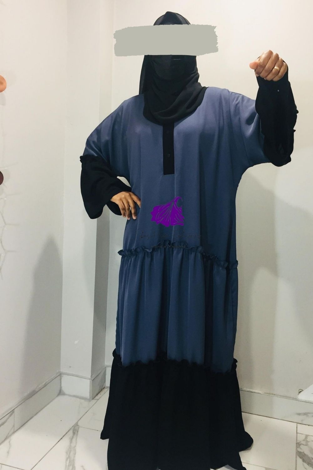 muslim woman standing with her hands out in a abaya
